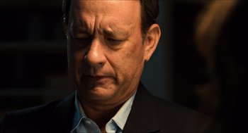 Movie still from “Inferno” (2016), directed by Ron Howard – A person wearing a suit and tie; Close Up shot, Low angle