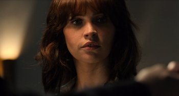 Movie still from “Inferno” (2016), directed by Ron Howard – A person with long brown hair; Close Up shot, Over the shoulder angle