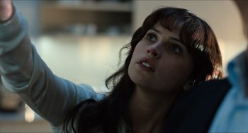 Movie still from “Inferno” (2016), directed by Ron Howard – A beautiful young lady sitting in front of a window; Close Up shot, Over the shoulder angle