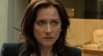 Movie still from “Inferno” (2016), directed by Ron Howard – A woman's face in a dark room; Close Up shot, Over the shoulder angle