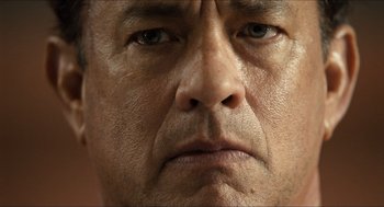 Movie still from “Inferno” (2016), directed by Ron Howard – A man's face with no expression of concern; Extreme Close Up shot, Low angle