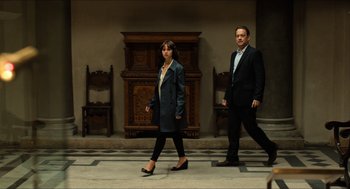 Movie still from “Inferno” (2016), directed by Ron Howard – A man and a woman walking down a hallway; Wide shot, Low angle