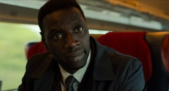 Movie still from “Inferno” (2016), directed by Ron Howard – A person wearing a suit and tie; Close Up shot, Over the shoulder angle