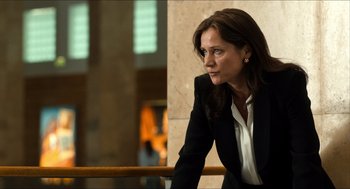 Movie still from “Inferno” (2016), directed by Ron Howard – A woman in a black jacket looking off into the distance; Medium shot, Low angle
