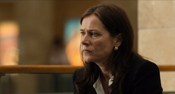 Movie still from “Inferno” (2016), directed by Ron Howard – A person sitting in front of a window; Close Up shot, Over the shoulder angle