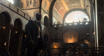 Movie still from “Inferno” (2016), directed by Ron Howard – A statue of a man in a suit in an old church; Extreme Wide shot, Low angle