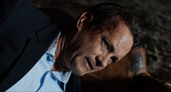 Movie still from “Inferno” (2016), directed by Ron Howard – A person wearing a suit and tie; Close Up shot, Overhead angle