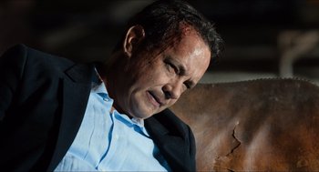 Movie still from “Inferno” (2016), directed by Ron Howard – A person wearing a suit and tie; Close Up shot, High angle