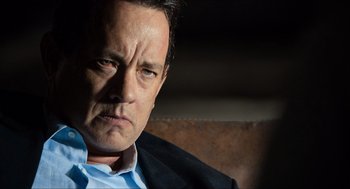 Movie still from “Inferno” (2016), directed by Ron Howard – A person wearing a suit and tie; Close Up shot, Over the shoulder angle