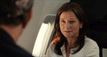 Movie still from “Inferno” (2016), directed by Ron Howard – A person sitting on a plane; Close Up shot, Over the shoulder angle