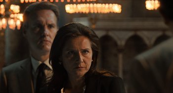 Movie still from “Inferno” (2016), directed by Ron Howard – A man and a woman standing next to each other in front of lights; Close Up shot, Low angle