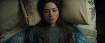 Movie still from “Ingrid Goes West” (2017), directed by Matt Spicer – A woman laying in a bed with a pillow; Close Up shot, Overhead angle