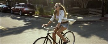 Movie still from “Ingrid Goes West” (2017), directed by Matt Spicer – A woman riding a bike down a street; Wide shot, High angle