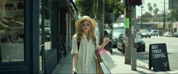 Movie still from “Ingrid Goes West” (2017), directed by Matt Spicer – A woman walking down a street holding a bag; Medium shot, Low angle