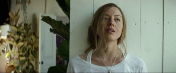 Movie still from “Ingrid Goes West” (2017), directed by Matt Spicer – A beautiful woman with long brown hair wearing a white shirt; Close Up shot, Low angle