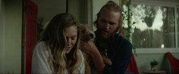 Movie still from “Ingrid Goes West” (2017), directed by Matt Spicer – A man and a woman holding a small dog; Close Up shot, Over the shoulder angle