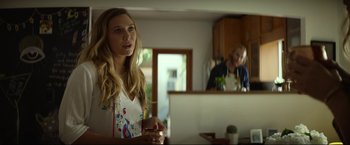 Movie still from “Ingrid Goes West” (2017), directed by Matt Spicer – A woman standing in front of an open laptop computer; Medium shot, Over the shoulder angle