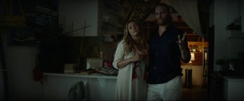 Movie still from “Ingrid Goes West” (2017), directed by Matt Spicer – A man and a woman standing next to each other in a room; Medium shot, Low angle