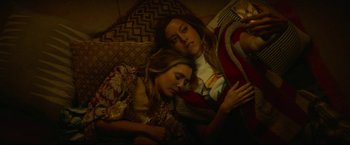 Movie still from “Ingrid Goes West” (2017), directed by Matt Spicer – Two young women are sleeping on a bed; Medium shot, Overhead angle