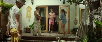 Movie still from “Ingrid Goes West” (2017), directed by Matt Spicer – A man and two women standing in front of a door; Wide shot, Low angle