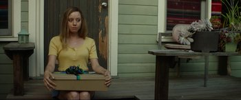 Movie still from “Ingrid Goes West” (2017), directed by Matt Spicer – A woman sitting on the ground holding a box; Medium shot, High angle