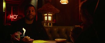 Movie still from “Ingrid Goes West” (2017), directed by Matt Spicer – A man sitting at a table in front of a bowl of food; Medium shot, Over the shoulder angle