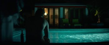 Movie still from “Ingrid Goes West” (2017), directed by Matt Spicer – A man sitting at the edge of a pool at night; Wide shot, Over the shoulder angle