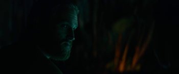 Movie still from “Ingrid Goes West” (2017), directed by Matt Spicer – A man with a beard is in the dark; Close Up shot, Over the shoulder angle
