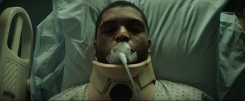 Movie still from “Ingrid Goes West” (2017), directed by Matt Spicer – A man with a neck brace on laying in a hospital bed; Close Up shot, Overhead angle
