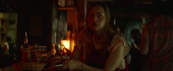 Movie still from “Ingrid Goes West” (2017), directed by Matt Spicer – A woman sitting in front of a fireplace; Medium shot, Over the shoulder angle