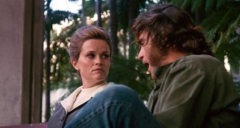 Movie still from “Inherent Vice” (2014), directed by Paul Thomas Anderson – A man and a woman are talking to each other; Medium shot, Low angle