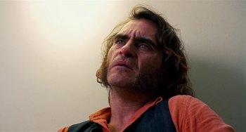 Movie still from “Inherent Vice” (2014), directed by Paul Thomas Anderson – A person with long hair; Close Up shot, Low angle