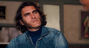 Movie still from “Inherent Vice” (2014), directed by Paul Thomas Anderson – A person with long hair; Close Up shot, Over the shoulder angle