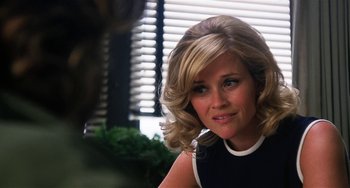 Movie still from “Inherent Vice” (2014), directed by Paul Thomas Anderson – A person wearing a black and white dress; Close Up shot, Over the shoulder angle