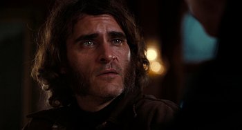 Movie still from “Inherent Vice” (2014), directed by Paul Thomas Anderson – A person with long hair; Close Up shot, Over the shoulder angle