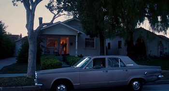 Movie still from “Inherent Vice” (2014), directed by Paul Thomas Anderson – A car parked in front of a house at night; Extreme Wide shot, Low angle