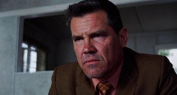 Movie still from “Inherent Vice” (2014), directed by Paul Thomas Anderson – A person wearing a suit and tie; Close Up shot, Low angle