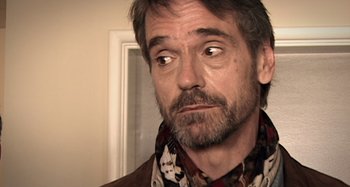 Movie still from “Inland Empire” (2006), directed by David Lynch – A person wearing a jacket; Close Up shot, Over the shoulder angle