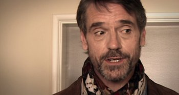 Movie still from “Inland Empire” (2006), directed by David Lynch – A person wearing a scarf; Close Up shot, Over the shoulder angle