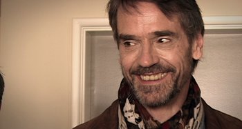 Movie still from “Inland Empire” (2006), directed by David Lynch – A person wearing a scarf; Close Up shot, Over the shoulder angle