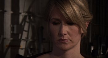 Movie still from “Inland Empire” (2006), directed by David Lynch – A person with her eyes closed; Close Up shot, Over the shoulder angle