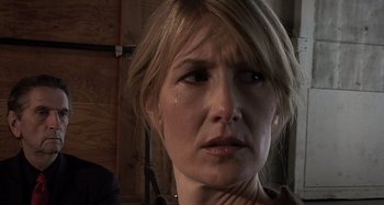 Movie still from “Inland Empire” (2006), directed by David Lynch – A person with her eyes wide open; Close Up shot, Over the shoulder angle