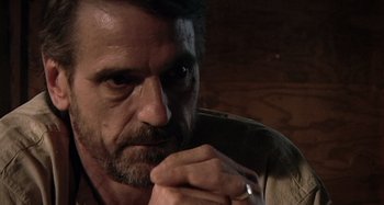 Movie still from “Inland Empire” (2006), directed by David Lynch – A person with his hand under his chin; Close Up shot, Over the shoulder angle