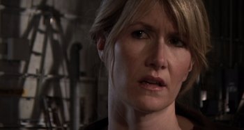 Movie still from “Inland Empire” (2006), directed by David Lynch – A woman's face in a dark room; Close Up shot, Over the shoulder angle