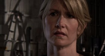 Movie still from “Inland Empire” (2006), directed by David Lynch – A person with short blonde hair; Close Up shot, Over the shoulder angle