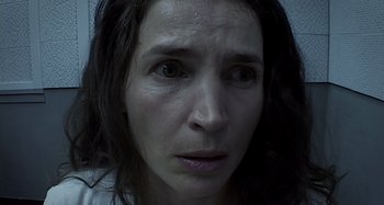 Movie still from “Inland Empire” (2006), directed by David Lynch – A woman's face in a black and white photo; Close Up shot, Low angle