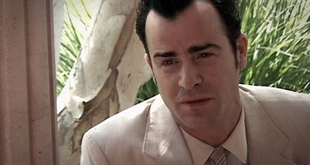 Movie still from “Inland Empire” (2006), directed by David Lynch – A person wearing a suit and tie; Close Up shot, High angle
