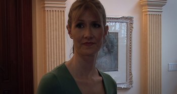 Movie still from “Inland Empire” (2006), directed by David Lynch – A woman standing in front of a painting; Close Up shot, Low angle