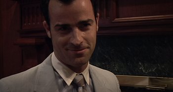 Movie still from “Inland Empire” (2006), directed by David Lynch – A person wearing a suit and tie; Close Up shot, High angle