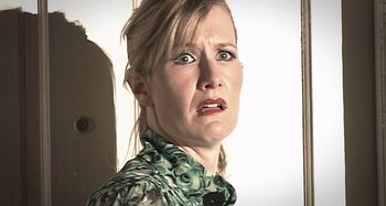 Movie still from “Inland Empire” (2006), directed by David Lynch – A person wearing a green shirt; Close Up shot, Low angle